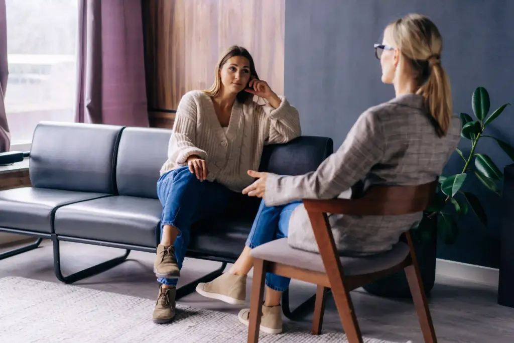Young woman speaking with her therapist.