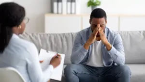 Man having a deep talk during a trauma therapy session with his counselor