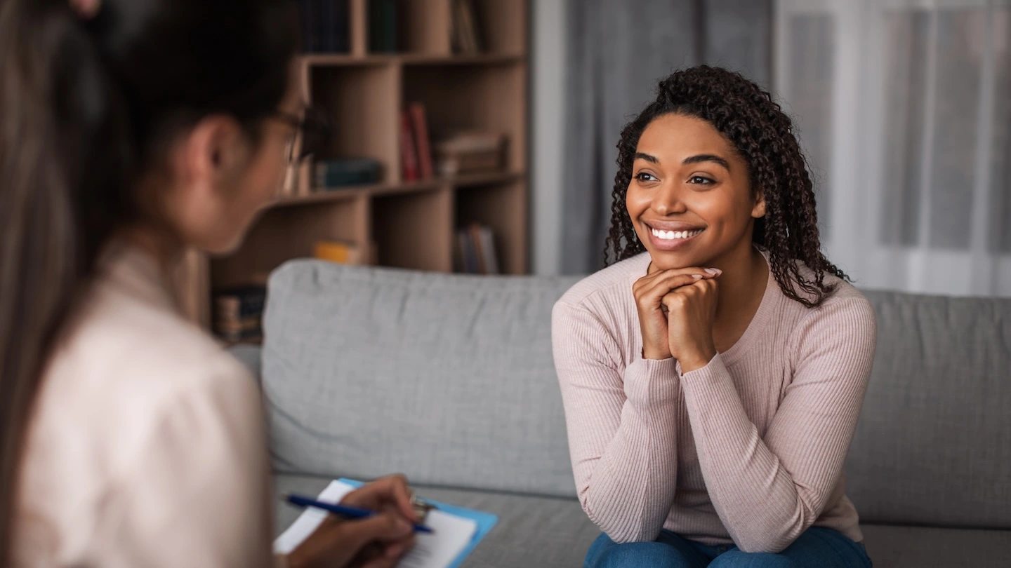 Smiling woman feeling relief in an anxiety therapy session in Austin